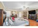 Primary bedroom with wood floors, closet and tv cabinet at 130 Honey Ln, Fayetteville, GA 30214