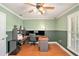 Well-lit home office with hardwood floors, dual monitors, and plantation shutters at 130 Honey Ln, Fayetteville, GA 30214