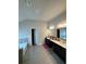 Well-lit bathroom featuring tile flooring, a soaking tub, and double vanity sinks at 419 Woodmill Way, Atlanta, GA 30331