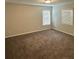 Bedroom with two large windows providing natural light, neutral walls, and gray carpeting at 419 Woodmill Way, Atlanta, GA 30331