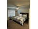Bedroom with a fan, window and bed with striped bedding at 419 Woodmill Way, Atlanta, GA 30331