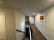 View of the carpeted hallway and stairs with neutral-toned walls and a decorative piece at 419 Woodmill Way, Atlanta, GA 30331