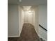Neutral hallway with gray carpeting, light gray walls, and white doors at 419 Woodmill Way, Atlanta, GA 30331