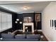 Stylish living room featuring a fireplace, dark accent wall, and a comfortable sofa at 419 Woodmill Way, Atlanta, GA 30331
