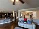 Open-concept living room with hardwood floors, modern furniture, and a glimpse of the updated kitchen at 419 Woodmill Way, Atlanta, GA 30331