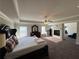 Spacious main bedroom featuring tray ceilings, a ceiling fan, and a fireplace at 419 Woodmill Way, Atlanta, GA 30331