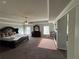 Spacious main bedroom featuring tray ceilings, a ceiling fan, and large windows at 419 Woodmill Way, Atlanta, GA 30331