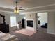 Spacious main bedroom featuring tray ceilings, a ceiling fan, and a fireplace at 419 Woodmill Way, Atlanta, GA 30331