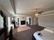Spacious main bedroom featuring tray ceilings, a ceiling fan, and a fireplace at 419 Woodmill Way, Atlanta, GA 30331