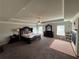 Spacious main bedroom featuring tray ceilings, a ceiling fan, and large windows at 419 Woodmill Way, Atlanta, GA 30331