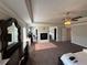 Spacious main bedroom featuring tray ceilings, a ceiling fan, and a fireplace at 419 Woodmill Way, Atlanta, GA 30331