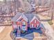 An aerial perspective of a red brick home highlighting its spacious yard and traditional design at 4213 Bretdale Nw Run, Kennesaw, GA 30152