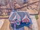 Elevated angle of home featuring mature landscaping, a dark roof, and a long driveway at 4213 Bretdale Nw Run, Kennesaw, GA 30152
