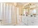 Bathroom featuring a tub with shower curtain and white dual sink vanity at 4213 Bretdale Nw Run, Kennesaw, GA 30152