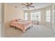 Bright bedroom with neutral walls, carpet and ceiling fan, plus large windows overlooking the property at 4213 Bretdale Nw Run, Kennesaw, GA 30152