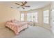 Bright bedroom with neutral walls, carpet and ceiling fan, plus large windows overlooking the property at 4213 Bretdale Nw Run, Kennesaw, GA 30152