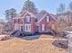Beautiful red brick house showcasing manicured landscaping, a bay window, and a well-maintained lawn at 4213 Bretdale Nw Run, Kennesaw, GA 30152