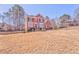 Charming two-story brick home with green grass in front and mature trees at 4213 Bretdale Nw Run, Kennesaw, GA 30152