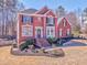 Classic red brick home with black shutters, a landscaped yard, and a welcoming front porch at 4213 Bretdale Nw Run, Kennesaw, GA 30152