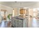 Open kitchen with an island cooktop that flows into the living area with dark hardwood floors at 4213 Bretdale Nw Run, Kennesaw, GA 30152