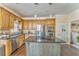 A kitchen with stainless steel appliances, granite countertops, and a view of the laundry room at 4213 Bretdale Nw Run, Kennesaw, GA 30152