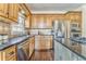 Classic kitchen with dark countertops, stainless steel appliances, and warm wood cabinets at 4213 Bretdale Nw Run, Kennesaw, GA 30152