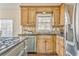 Bright kitchen featuring stainless steel appliances, wooden cabinets, granite countertops, and hardwood floors at 4213 Bretdale Nw Run, Kennesaw, GA 30152