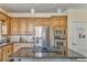 Spacious kitchen featuring stainless steel appliances, wooden cabinets, and a granite-topped island with cooktop at 4213 Bretdale Nw Run, Kennesaw, GA 30152