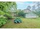 Home backyard with green grass, landscaping, a screened in back porch, and a wooden fence at 4244 Dorsey Sw Ct, Lilburn, GA 30047