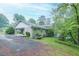 Brick home with a car port and green grass and several small bushes out back at 4244 Dorsey Sw Ct, Lilburn, GA 30047