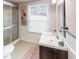 Clean bathroom with tiled shower, sink vanity and light fixture at 4244 Dorsey Sw Ct, Lilburn, GA 30047