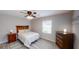 Well-lit bedroom featuring wood-look flooring, ceiling fan, and modern decor at 4244 Dorsey Sw Ct, Lilburn, GA 30047