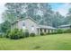 A well-kept brick home with a spacious lawn, complemented by mature trees in a serene, natural setting at 4244 Dorsey Sw Ct, Lilburn, GA 30047
