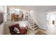 Inviting living area featuring a cozy chair, hardwood floors, and bright natural light from the open-concept design at 4244 Dorsey Sw Ct, Lilburn, GA 30047