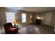 A comfortable living space with hardwood floors and natural light features a stylish chair and functional furniture at 4244 Dorsey Sw Ct, Lilburn, GA 30047