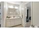 A bright bathroom featuring a vanity sink and mirror, with an open doorway to another room at 5006 Dantel Way, Stone Mountain, GA 30083
