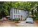 Charming two-story home with blue siding and a well-maintained yard surrounded by lush trees providing lots of shade at 5006 Dantel Way, Stone Mountain, GA 30083
