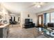 Inviting living room featuring plush sofas, a glass coffee table, and an open view to the dining area at 5006 Dantel Way, Stone Mountain, GA 30083