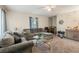 Comfortable living room featuring plush sofas, a glass coffee table, and natural light streaming through the windows at 5006 Dantel Way, Stone Mountain, GA 30083