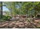 View of the home's spacious backyard and patio with a pool, surrounded by lush trees for added privacy at 5222 Skyline Dr, Stone Mountain, GA 30083