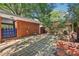 Charming backyard area with a brick patio, privacy fence, and blue gate at 5222 Skyline Dr, Stone Mountain, GA 30083