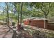 Large backyard showing a brick home exterior, a brick patio with firepit, and partial pool view at 5222 Skyline Dr, Stone Mountain, GA 30083