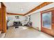 Cozy basement featuring wood-paneled accents, a white sofa, and a door leading to the outside at 5222 Skyline Dr, Stone Mountain, GA 30083