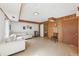 Finished basement area featuring wood-paneled walls, white sofa, and access to additional rooms at 5222 Skyline Dr, Stone Mountain, GA 30083