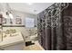 Bathroom featuring vintage tile, black accents and shower/tub combo with patterned curtain at 5222 Skyline Dr, Stone Mountain, GA 30083