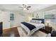 Cozy bedroom with ceiling fan, hardwood floors, and natural light from multiple windows at 5222 Skyline Dr, Stone Mountain, GA 30083