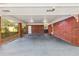 Open carport area with brick columns and walls, providing covered parking and access to the home at 5222 Skyline Dr, Stone Mountain, GA 30083