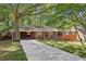 Charming brick home featuring a long driveway and lush landscaping with a cozy front porch at 5222 Skyline Dr, Stone Mountain, GA 30083