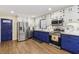 Bright kitchen featuring modern stainless steel appliances, and stylish blue and white cabinetry at 5222 Skyline Dr, Stone Mountain, GA 30083