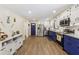 Spacious kitchen featuring white and blue cabinets, stainless steel appliances, and granite countertops at 5222 Skyline Dr, Stone Mountain, GA 30083